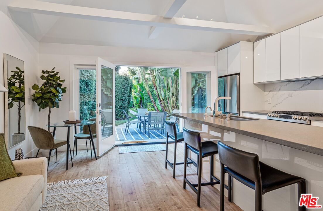 4216 Woodcliff Road Sherman Oaks, CA 91403 - Photo 39 of 56 a dining room with furniture window and wooden floor
