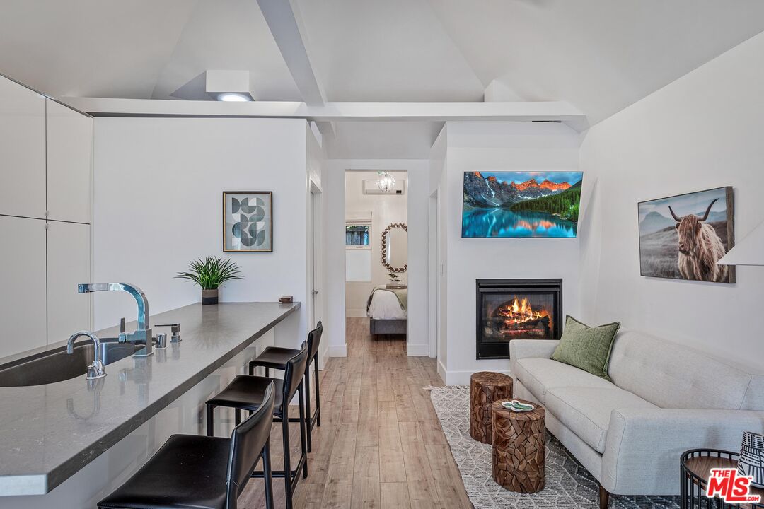 4216 Woodcliff Road Sherman Oaks, CA 91403 - Photo 40 of 56 a living room with furniture and a fireplace