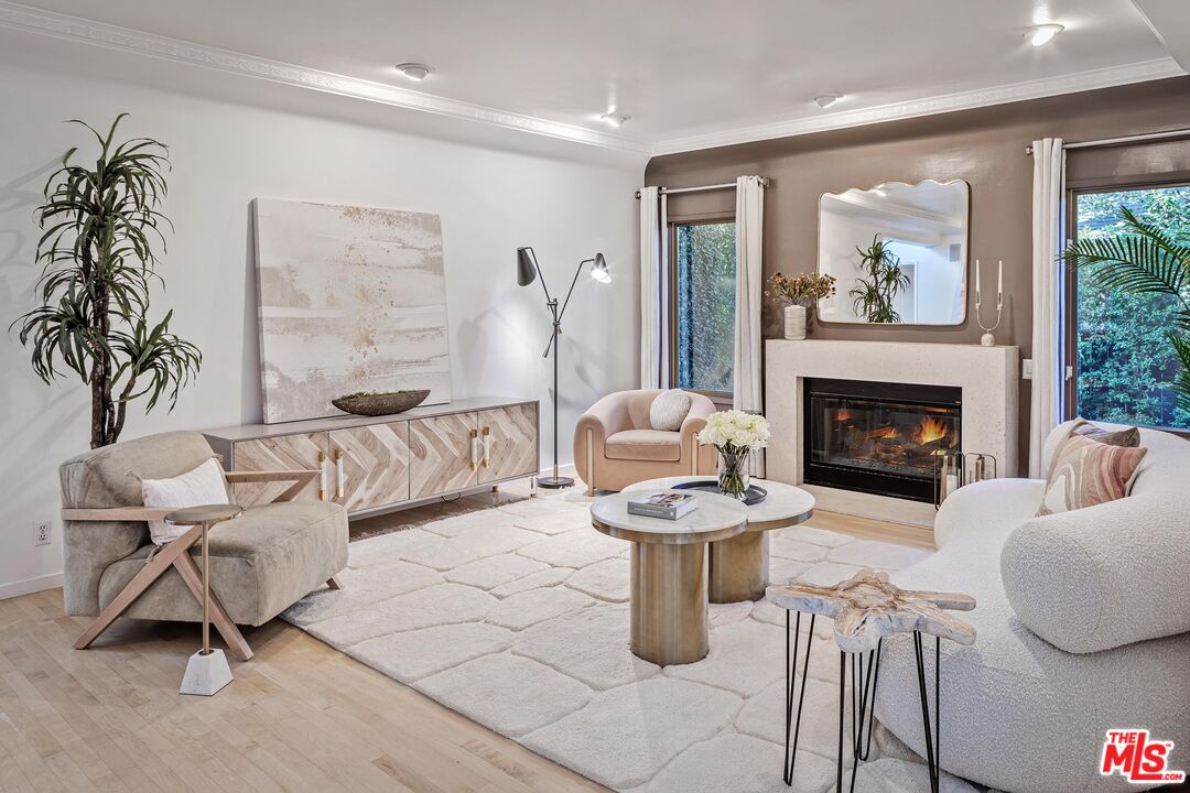 4216 Woodcliff Road Sherman Oaks, CA 91403 - Photo 4 of 56 a living room with furniture a fireplace and a potted plant