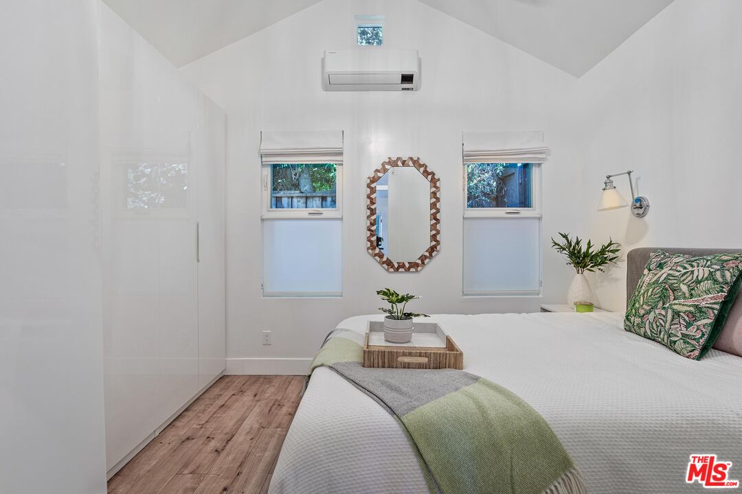4216 Woodcliff Road Sherman Oaks, CA 91403 - Photo 41 of 56 a bedroom with a bed and a mirror