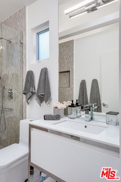 4216 Woodcliff Road Sherman Oaks, CA 91403 - Photo 46 of 56 a bathroom with a sink and a mirror