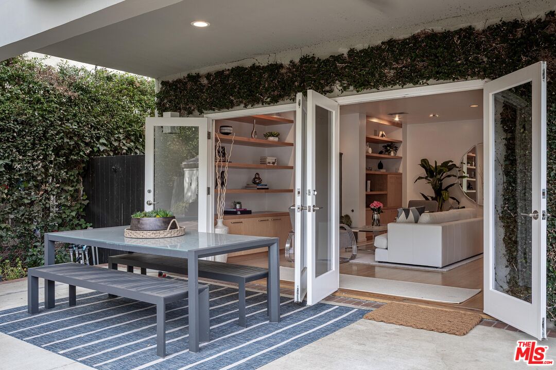 4216 Woodcliff Road Sherman Oaks, CA 91403 - Photo 51 of 56 a view of a patio with table and chairs with wooden floor and fence