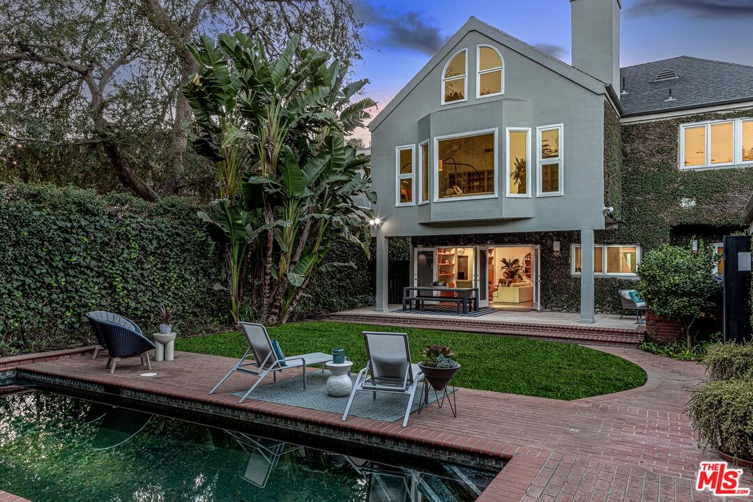 4216 Woodcliff Road Sherman Oaks, CA 91403 - Photo 53 of 56 a front view of a house with a yard table and chairs
