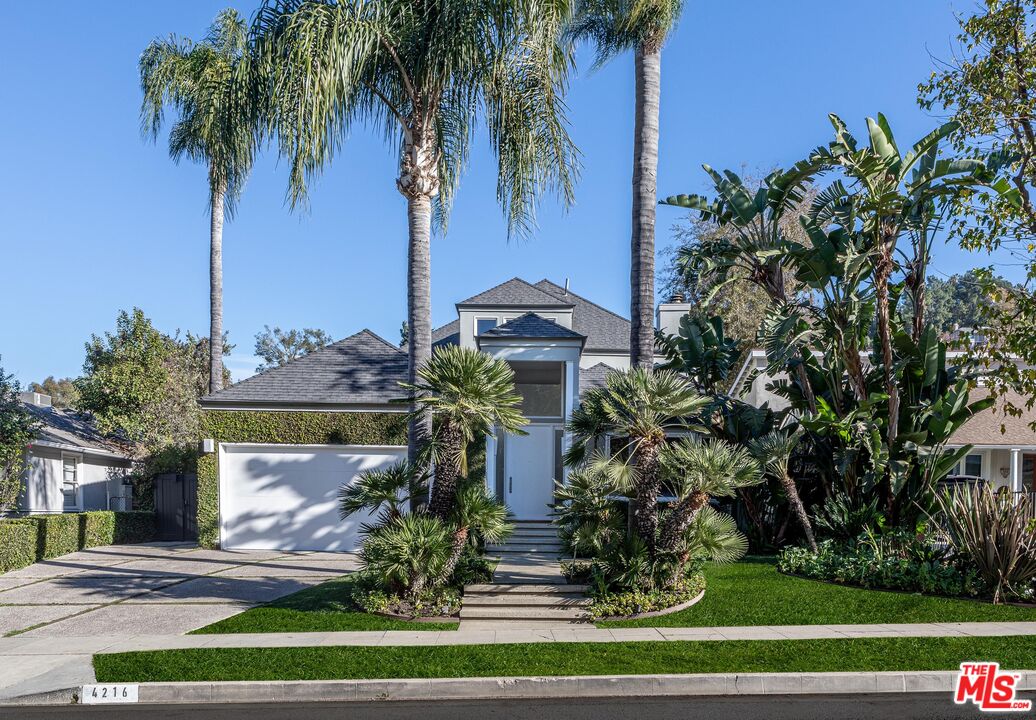 4216 Woodcliff Road Sherman Oaks, CA 91403 - Photo 56 of 56 a front view of a house with garden