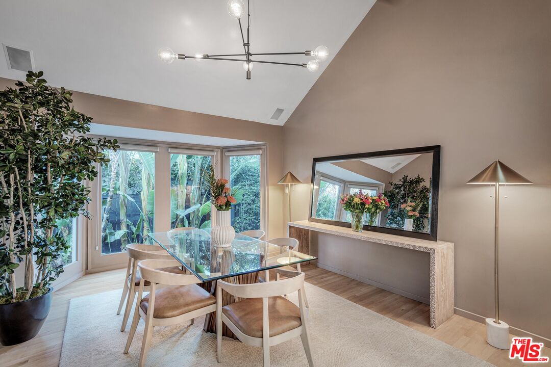 4216 Woodcliff Road Sherman Oaks, CA 91403 - Photo 6 of 56 a dining room with furniture a chandelier and window