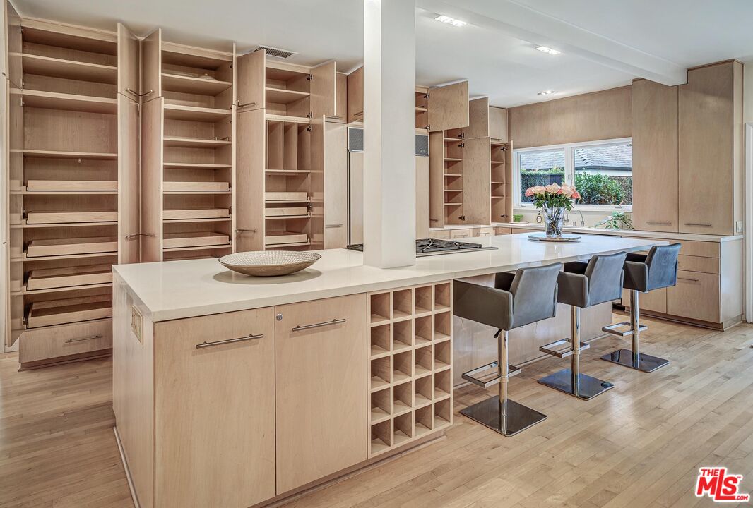 4216 Woodcliff Road Sherman Oaks, CA 91403 - Photo 9 of 56 a kitchen with a sink a table and chairs in it