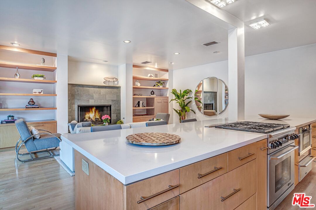 4216 Woodcliff Road Sherman Oaks, CA 91403 - Photo 10 of 56 a kitchen with a stove and a wooden floor