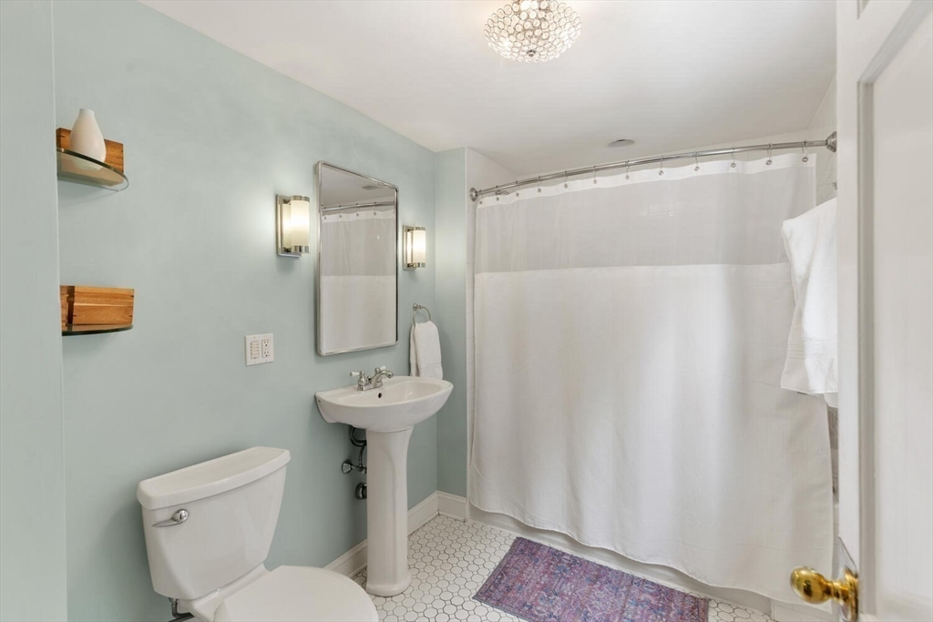 32 Kings Beach Terrace Swampscott, MA 01907 - Photo 28 of 40 a bathroom with a sink mirror toilet and shower