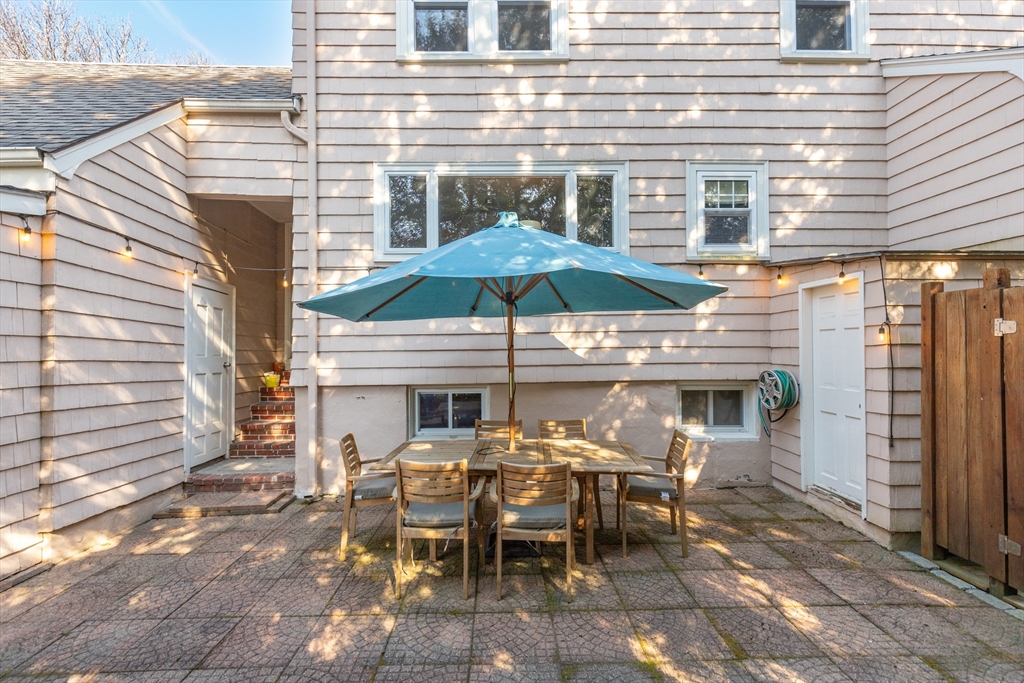 32 Kings Beach Terrace Swampscott, MA 01907 - Photo 9 of 40 a patio with a table and chairs under an umbrella