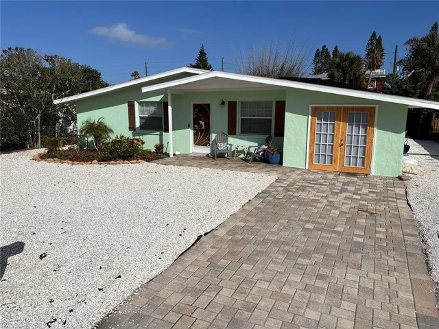 a front view of a house with garden and porch