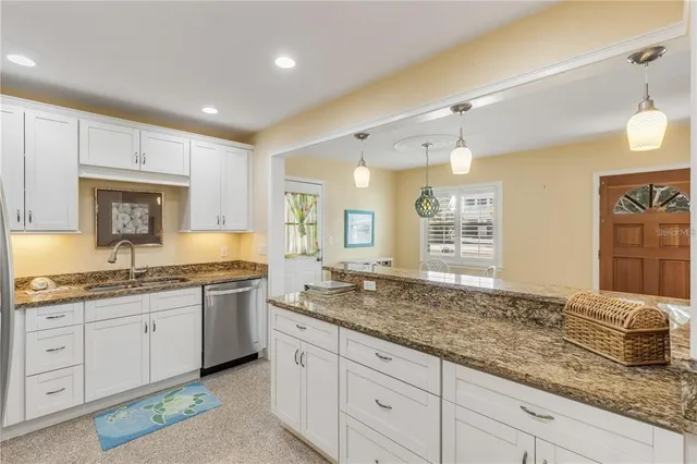 a bathroom with sink granite and bathtub