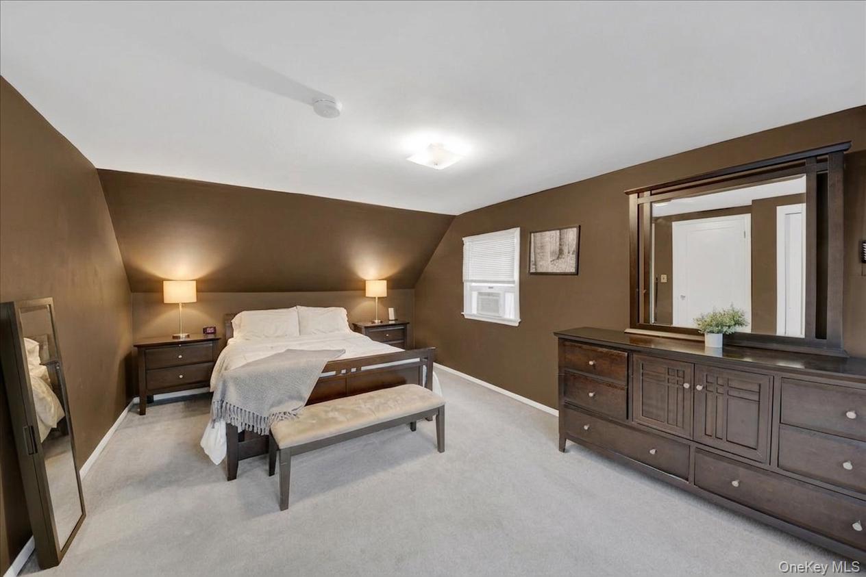 10 Susquehanna Road Ossining, NY 10562 - Photo 16 of 31 2nd floor bedroom featuring vaulted ceilings, soft gray wall-to-wall carpeting, and a built-in window unit