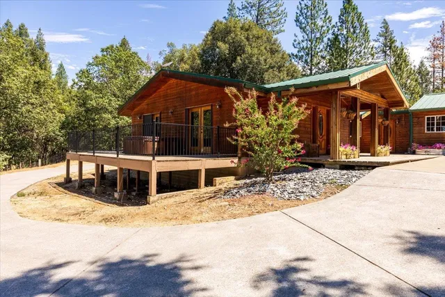 a view of a house with wooden fence