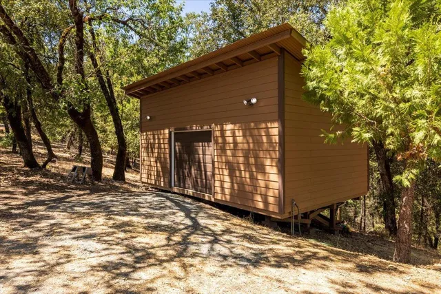 a backyard of a house with a tree