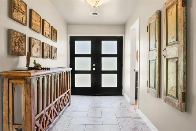 a spacious bedroom with a bed and a chandelier