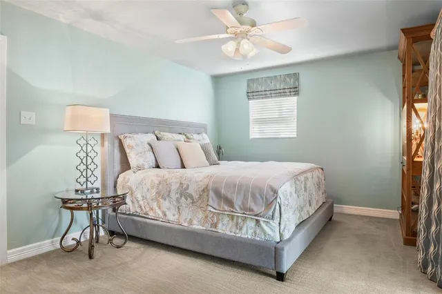 a view of a balcony with chairs and an umbrella