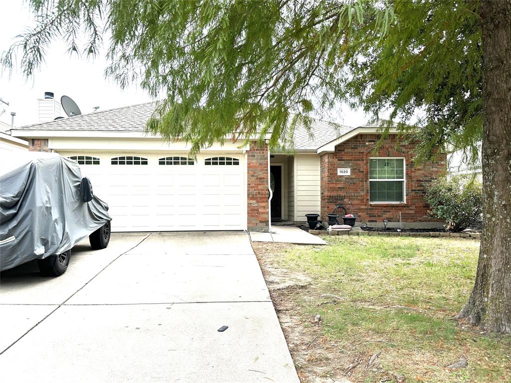 a view of a patio with a table and chairs under an umbrella