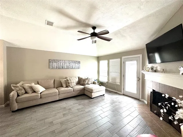 a living room with furniture fireplace and flat screen tv