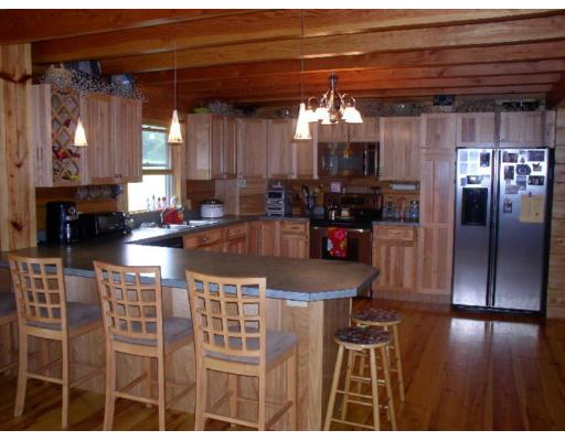 122 Adams Road Grafton, MA 01536 - Photo 3 of 9 a kitchen with refrigerator and cabinets