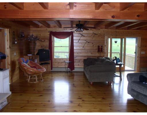 122 Adams Road Grafton, MA 01536 - Photo 6 of 9 a living room with fireplace furniture and a wooden floor