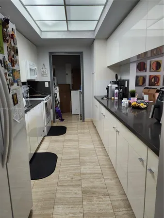 a kitchen with stainless steel appliances kitchen island granite countertop a sink and cabinets