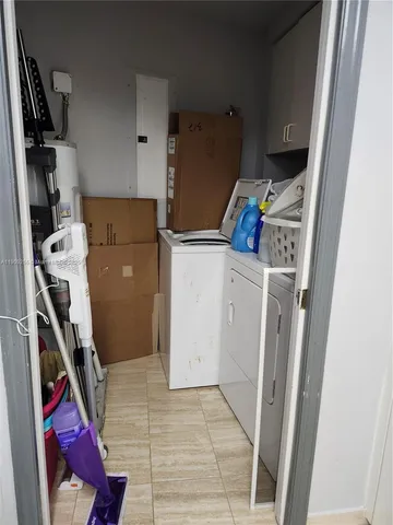 a storage and utility room with a washer dryer