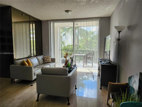 a living room with furniture and a floor to ceiling window