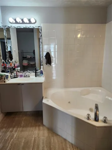 a bathroom with a sink vanity and mirror