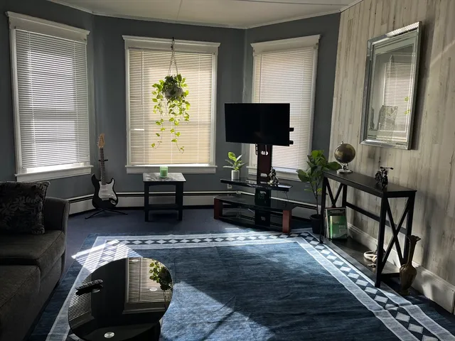 a living room with fireplace furniture and a flat screen tv