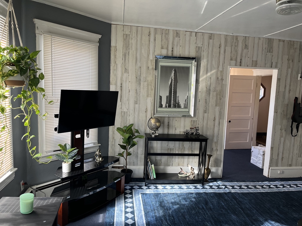 83 Madison Street Chicopee, MA 01020 - Photo 3 of 5 a living room with furniture and a fireplace