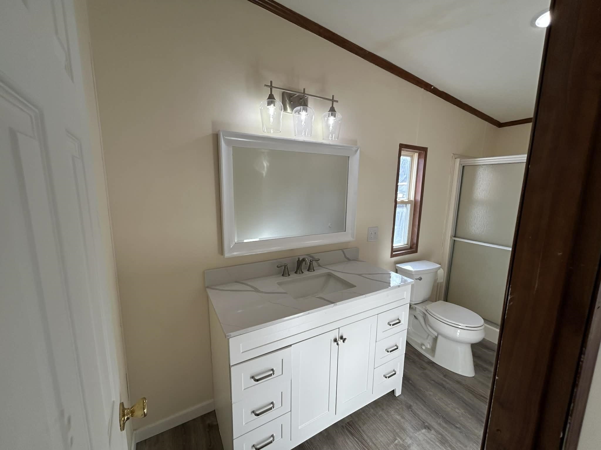 104 Bentwood Drive Blue Ridge, VA 24064 - Photo 14 of 19 a bathroom with a double vanity sink and mirror with toilet