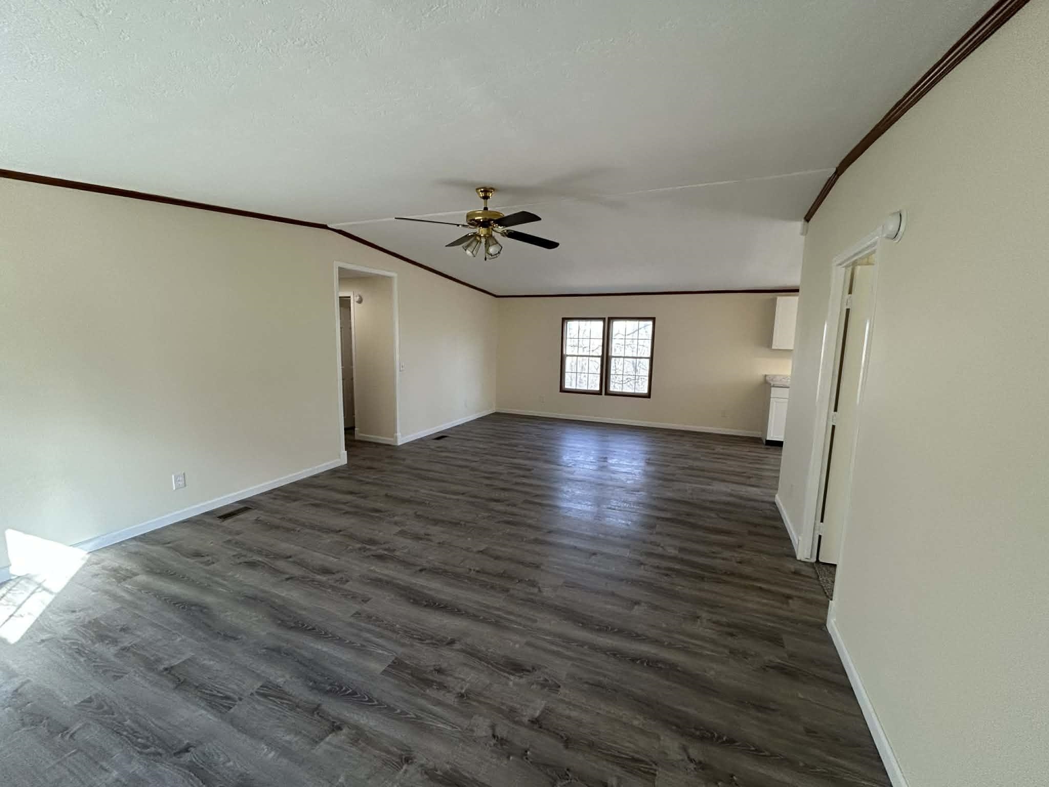 104 Bentwood Drive Blue Ridge, VA 24064 - Photo 7 of 19 a view of a livingroom with wooden floor and a ceiling fan