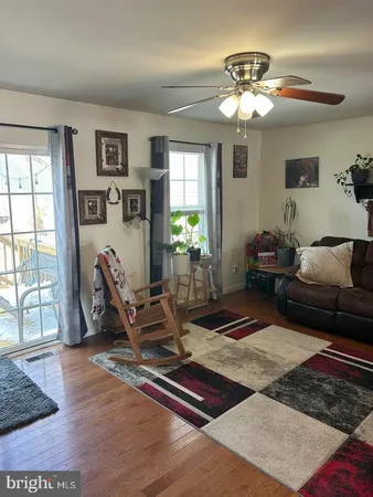 a living room with furniture and wooden floor
