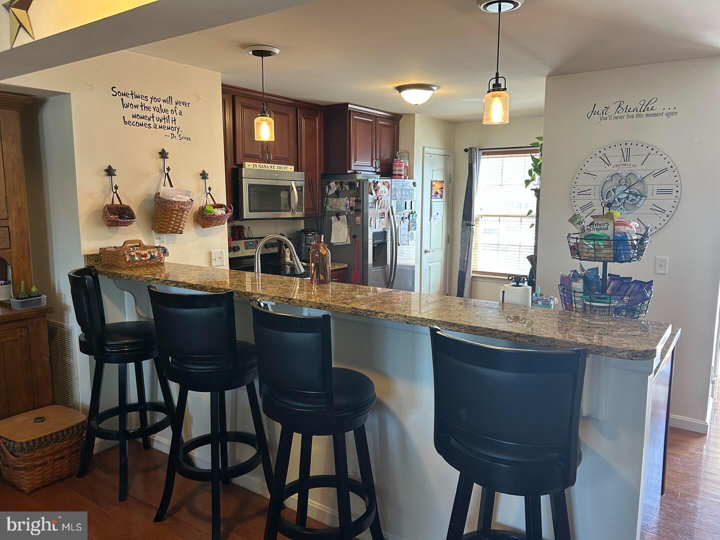 169 Medal Way Magnolia, DE 19962 - Photo 5 of 13 a kitchen with granite countertop a table chairs stove and cabinets