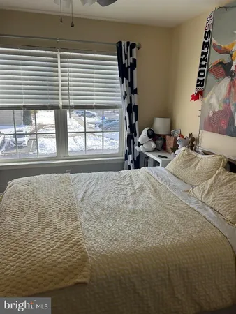 a bed sitting in a bedroom next to a window