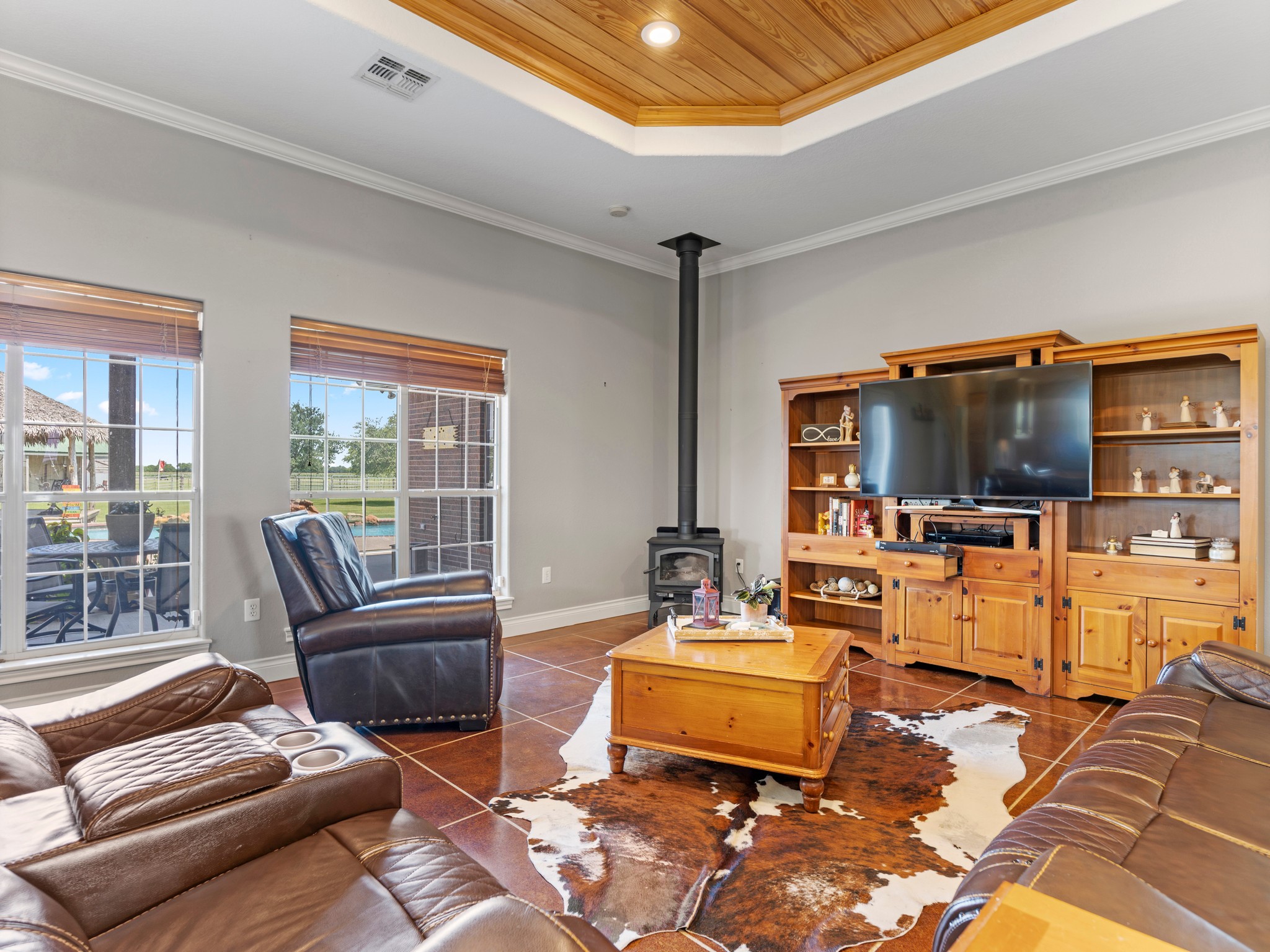10630 Brinkmeyer Road Needville, TX 77461 - Photo 12 of 50 a living room with furniture a flat screen tv and a floor to ceiling window