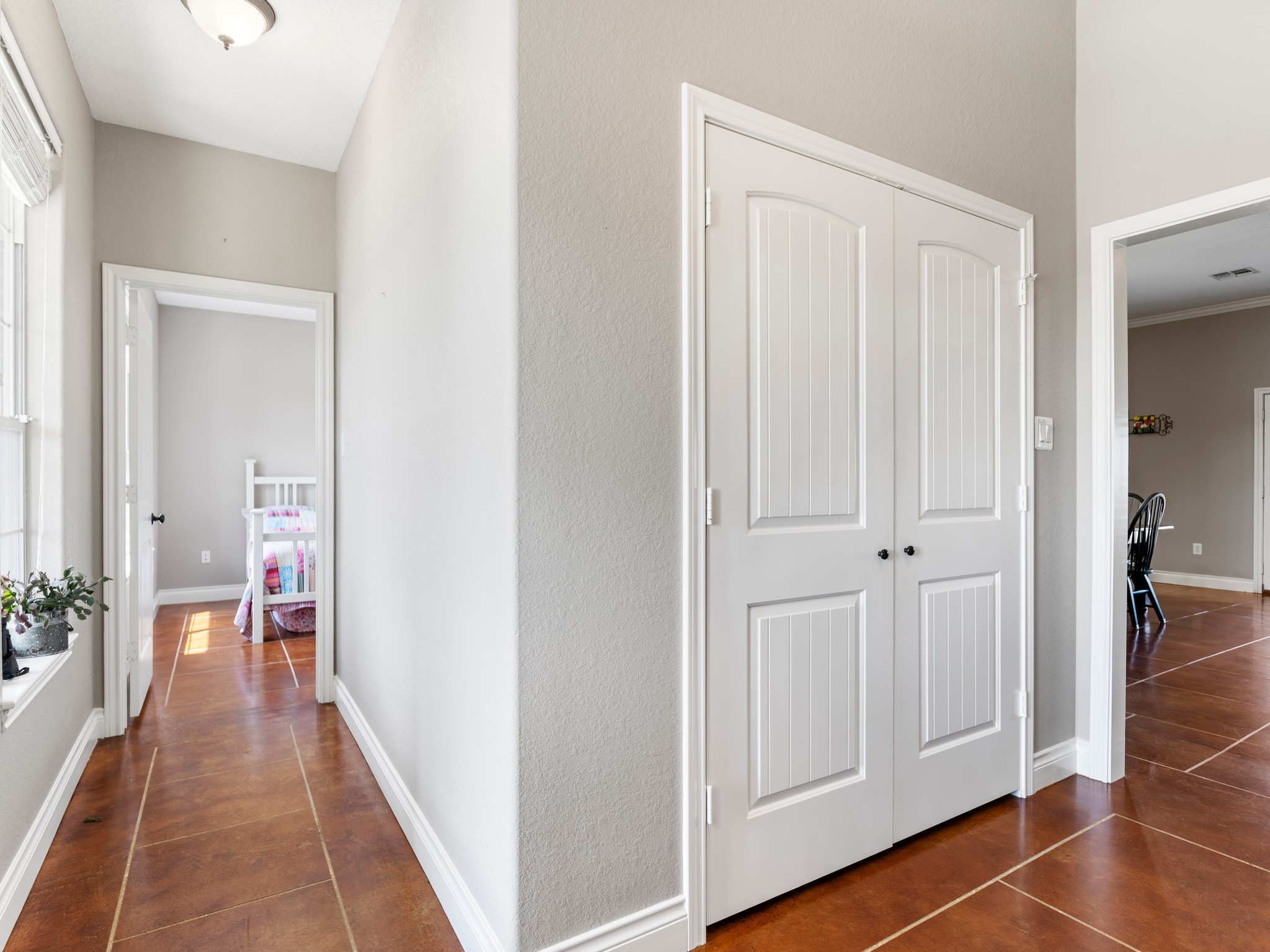 10630 Brinkmeyer Road Needville, TX 77461 - Photo 20 of 50 a hallway with white doors wooden floor and stairs
