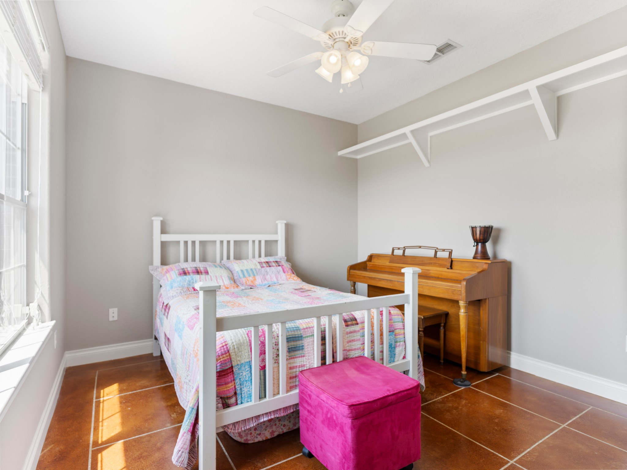 10630 Brinkmeyer Road Needville, TX 77461 - Photo 21 of 50 a bedroom with a bed and a chandelier
