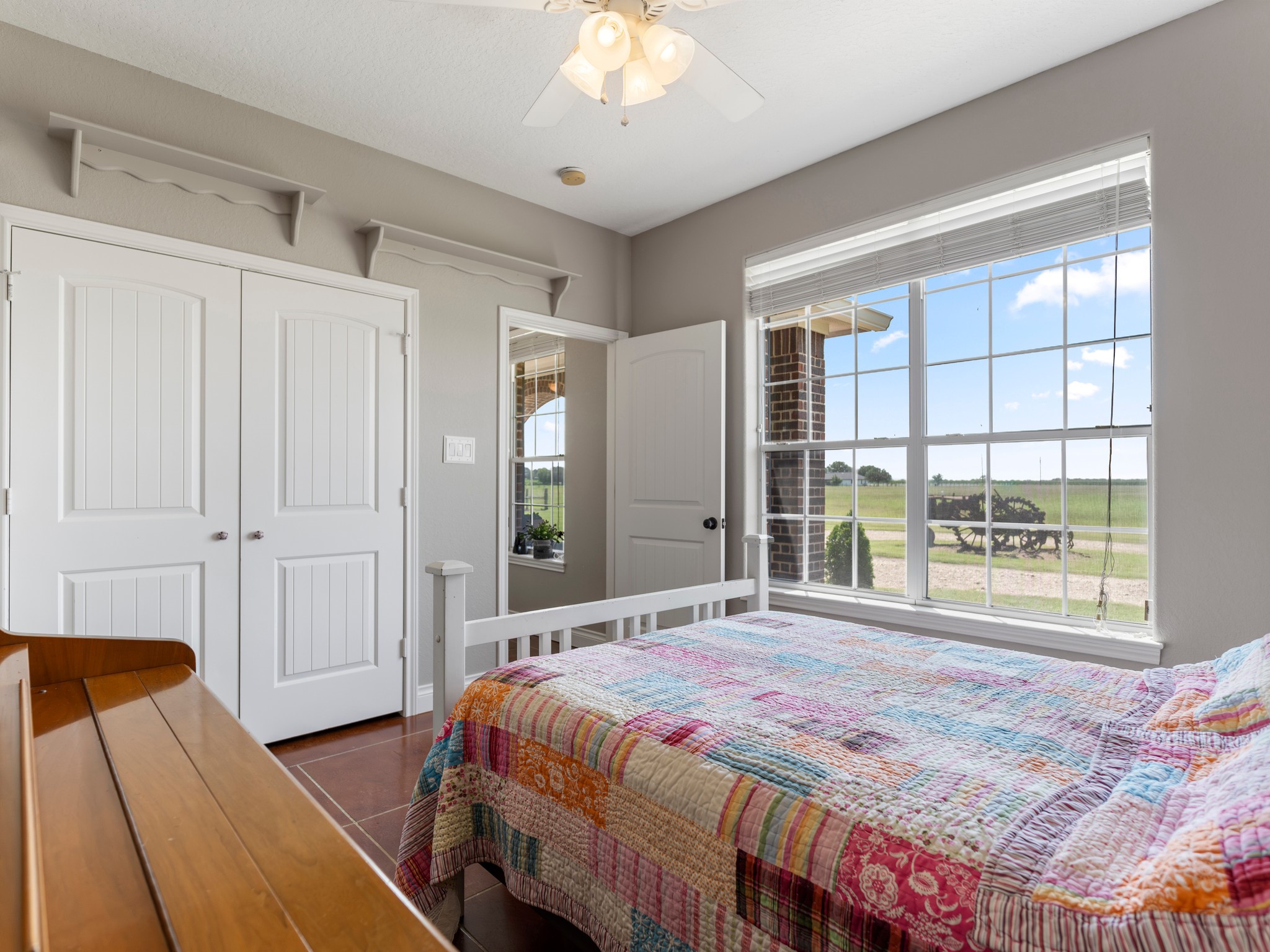 10630 Brinkmeyer Road Needville, TX 77461 - Photo 22 of 50 a bedroom with a bed and a large window