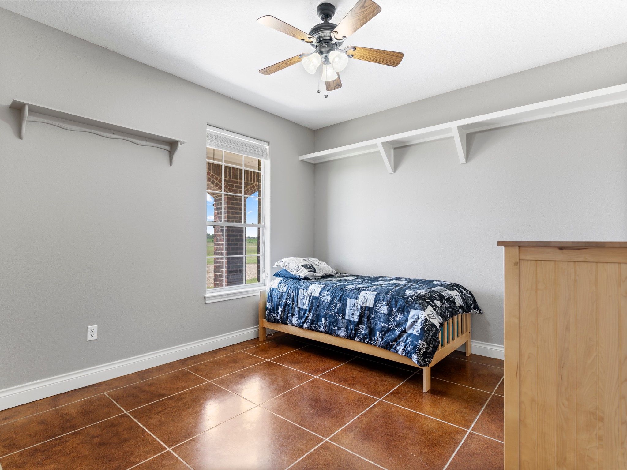 10630 Brinkmeyer Road Needville, TX 77461 - Photo 27 of 50 a bedroom with a bed and a window