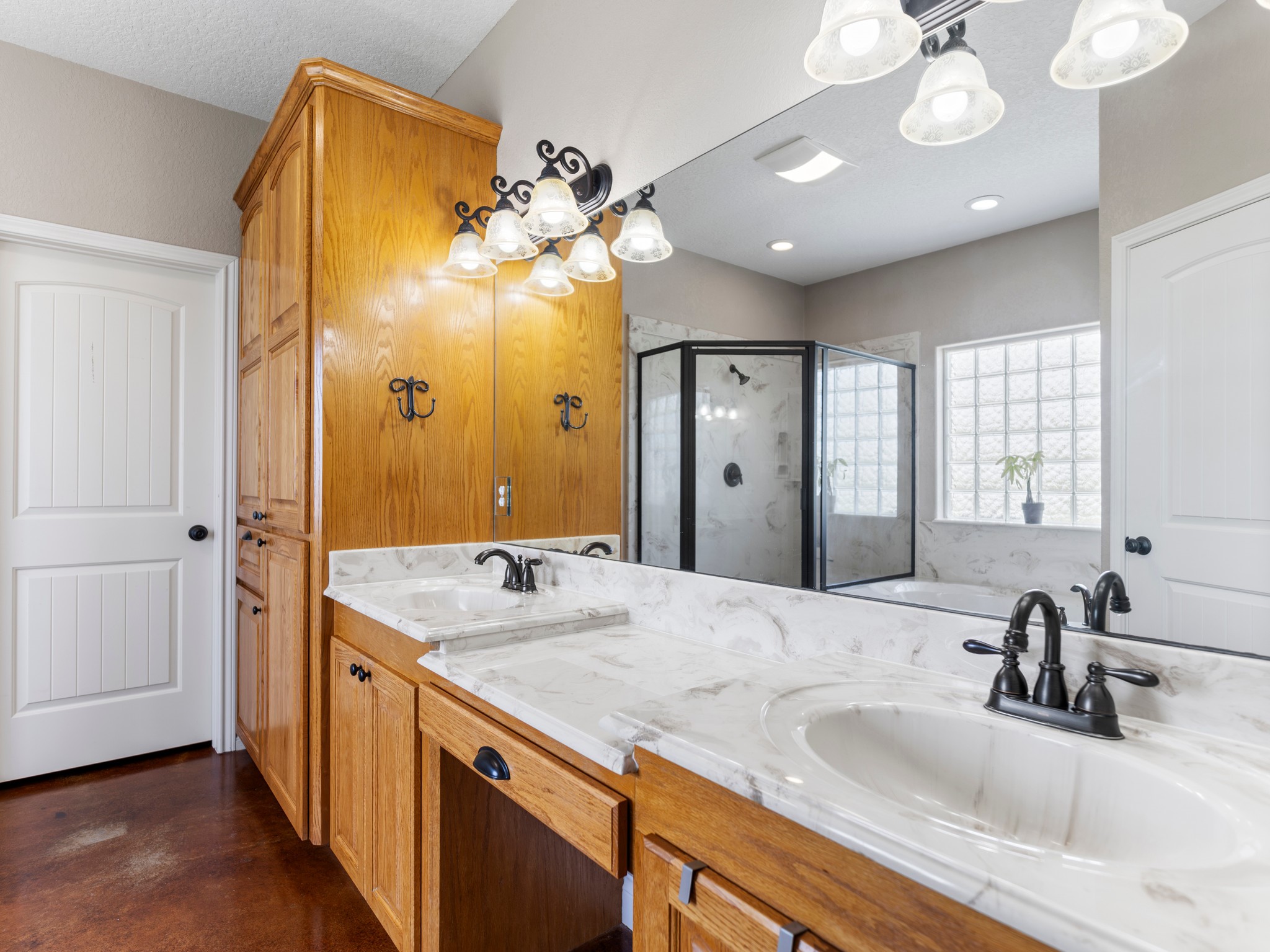 10630 Brinkmeyer Road Needville, TX 77461 - Photo 31 of 50 a bathroom with a granite countertop sink a large mirror and a shower