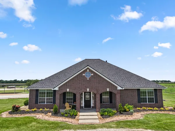 a front view of a house with garden