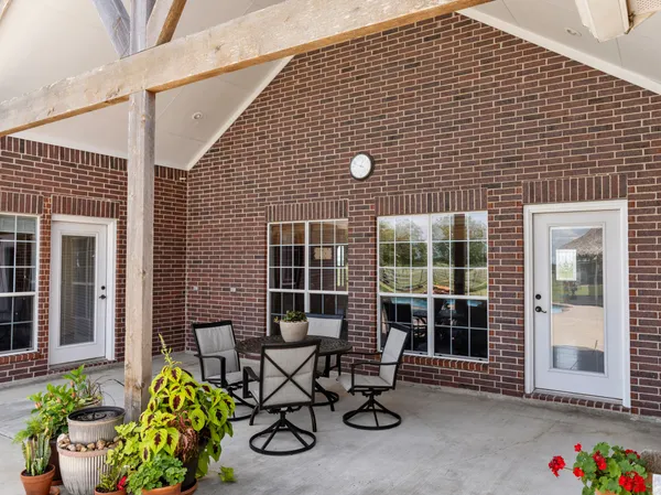 a front view of a house with sitting area