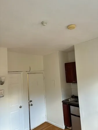 a view of a closet area with wooden floor