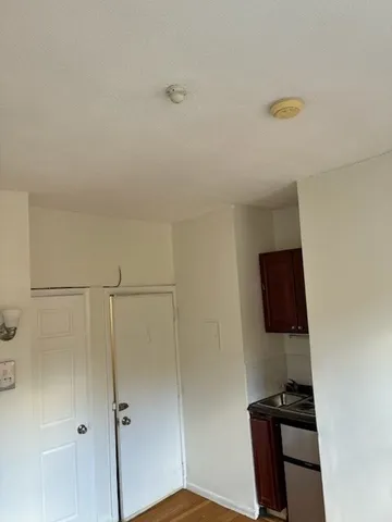 a view of a closet area with wooden floor