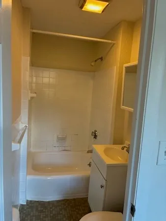 a bathroom with a shower and a toilet