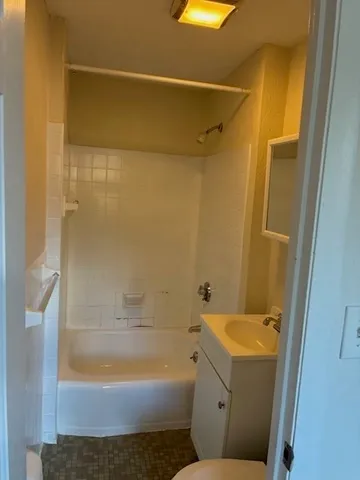 a bathroom with a shower and a toilet