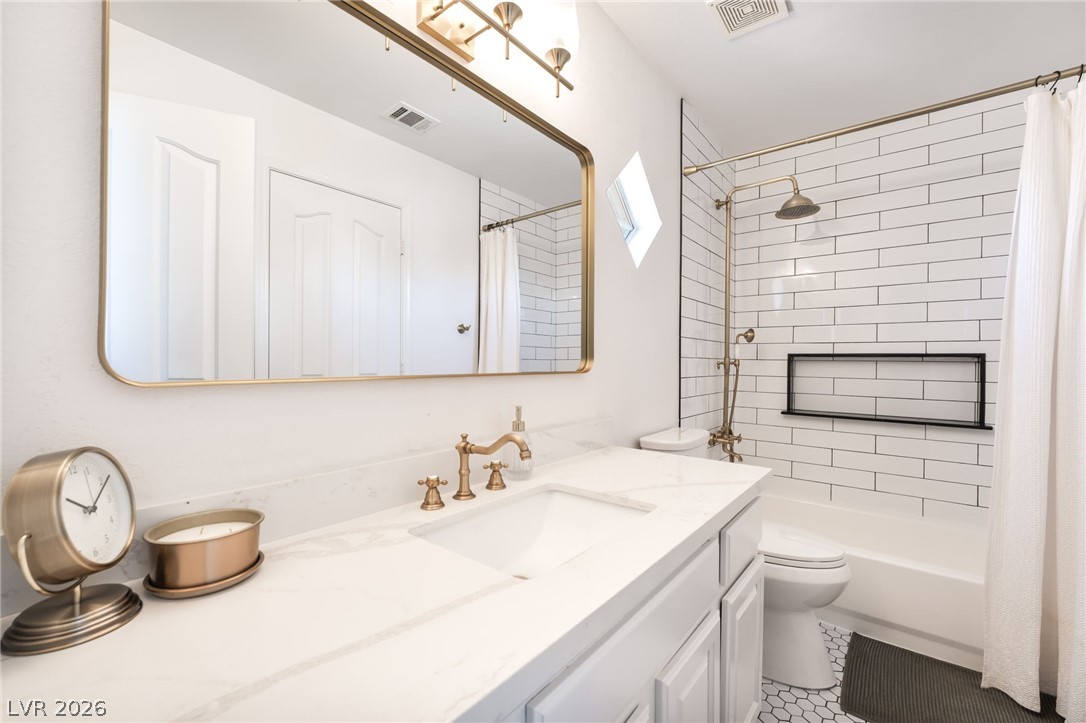 1941 Ivy Point Lane Las Vegas, NV 89134 - Photo 13 of 21 This elegant bathroom features a large vanity, contemporary fixtures, and subway tile shower surround.