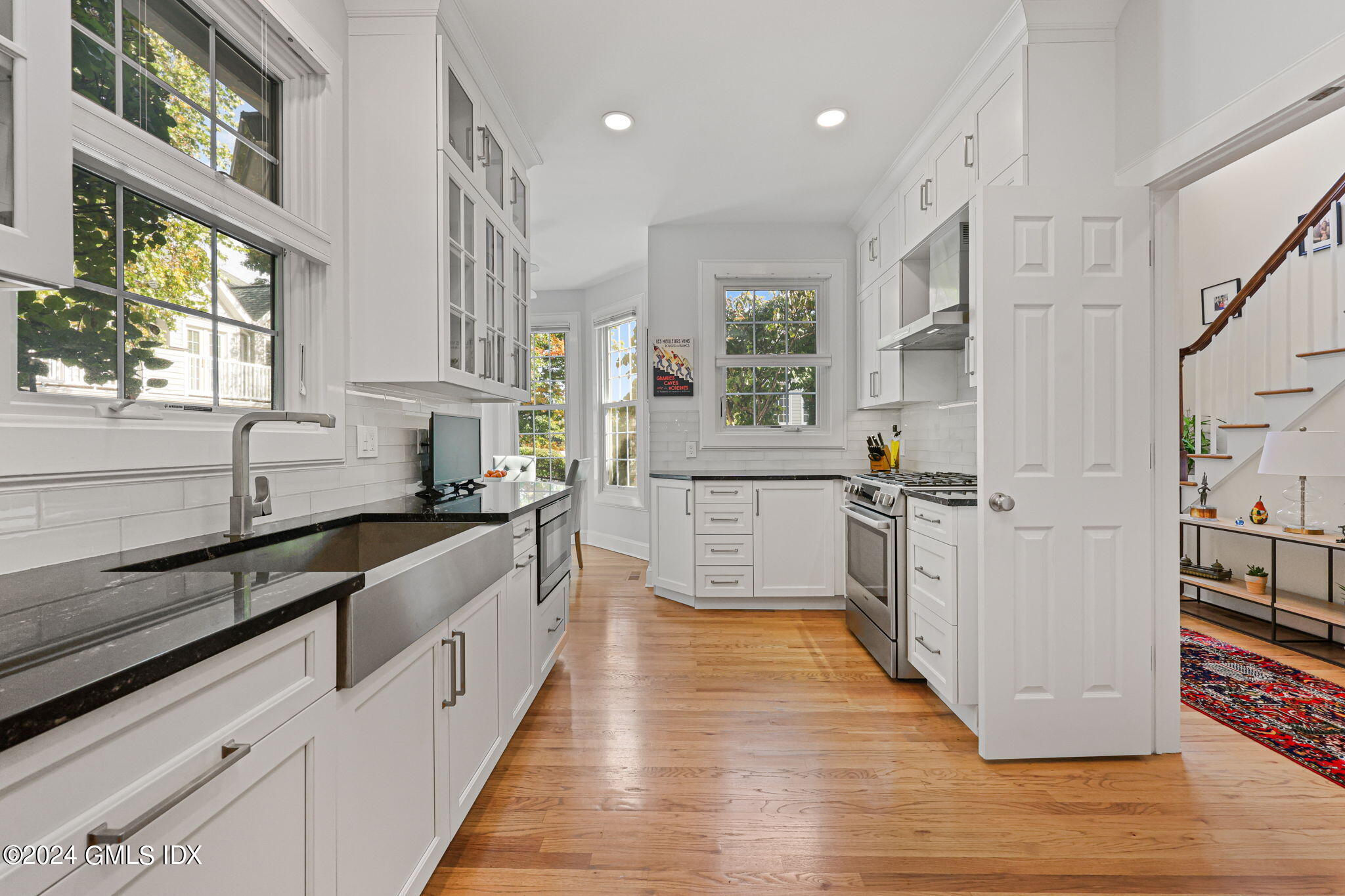 48 Spring Street, Unit 8 Greenwich, CT 06830 - Photo 11 of 24 a large kitchen with stainless steel appliances a sink and window