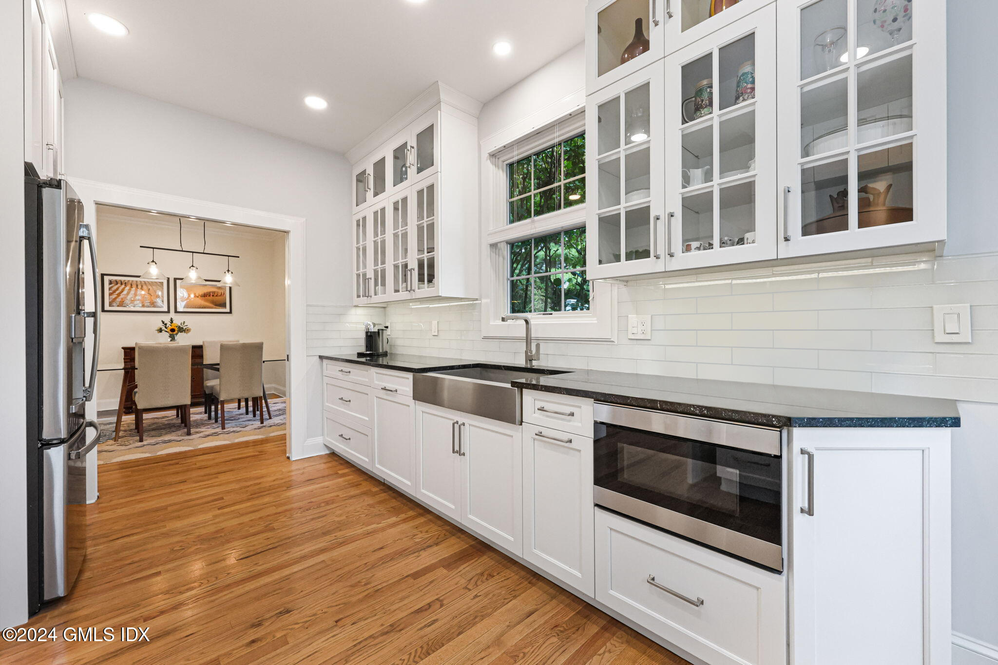 48 Spring Street, Unit 8 Greenwich, CT 06830 - Photo 13 of 24 a kitchen with stainless steel appliances kitchen island granite countertop a stove and a sink